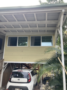 Exterior view of a house with new window installation and carport repair by Handyman Jeff in Keaau, HI