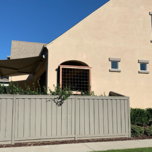 Exterior view of a custom arched window installation and fence work by J.V. Repairs in Sacramento, CA.