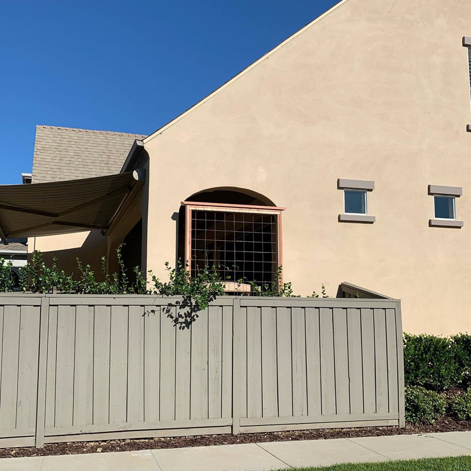 Exterior view of a custom arched window installation and fence work by J.V. Repairs in Sacramento, CA.