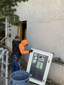 Handymen from Nordic Construction replacing an exterior window on a home in Plymouth, MN.
