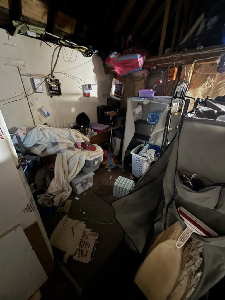 An extremely cluttered attic space filled with various items, indicating a large junk removal project for DJ's Junk Removal in Laconia, NH.