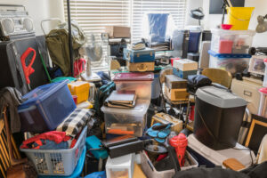 An extremely cluttered room with items piled high, a typical scene before a cleanout by Junk Movers in Salt Lake City, UT.