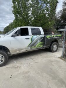 A fallen tree and large branches in a backyard, ready for green waste removal by Area 661 Hauling in Bakersfield, CA.