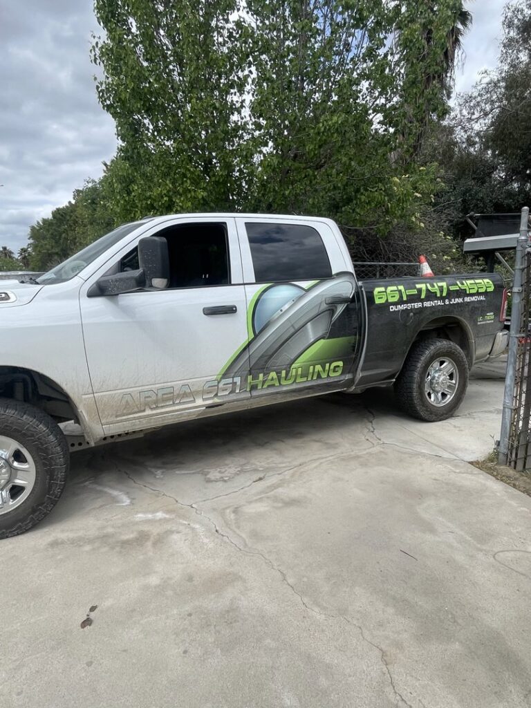 A fallen tree and large branches in a backyard, ready for green waste removal by Area 661 Hauling in Bakersfield, CA.