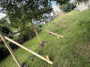 Wooden fence construction in progress, showing posts and supports, by Verkler Development LLC in Lake Charles, LA.