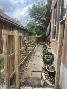A fence construction site with posts and panels being installed, demonstrating work by Triple A' Construction in San Antonio, TX.