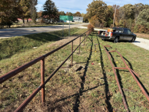 A metal fence being installed or repaired by Wild Hogs Handyman Service in Bentonville, AR.