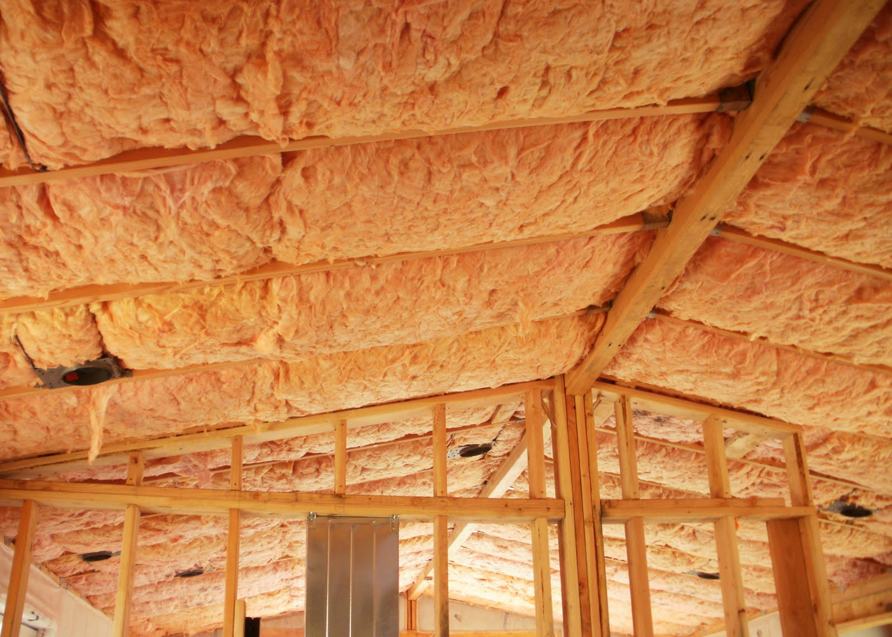 Fiberglass batt insulation installed in a ceiling and wall framing by Ohio Insulation & Manufacturing Co in Dayton, OH.
