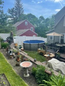 A beautifully finished above-ground pool in a residential backyard, installed by Advanced Pools and Repair, LLC in Bristol, CT.