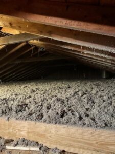 A view of a finished attic with a thick layer of blown-in insulation by Mincin Insulation Service Inc. in Pittsburgh, PA.
