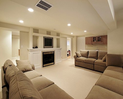 A finished basement living area featuring a cozy fireplace and a small wet bar, showcasing work by Paradise Found Construction in Cary, NC.