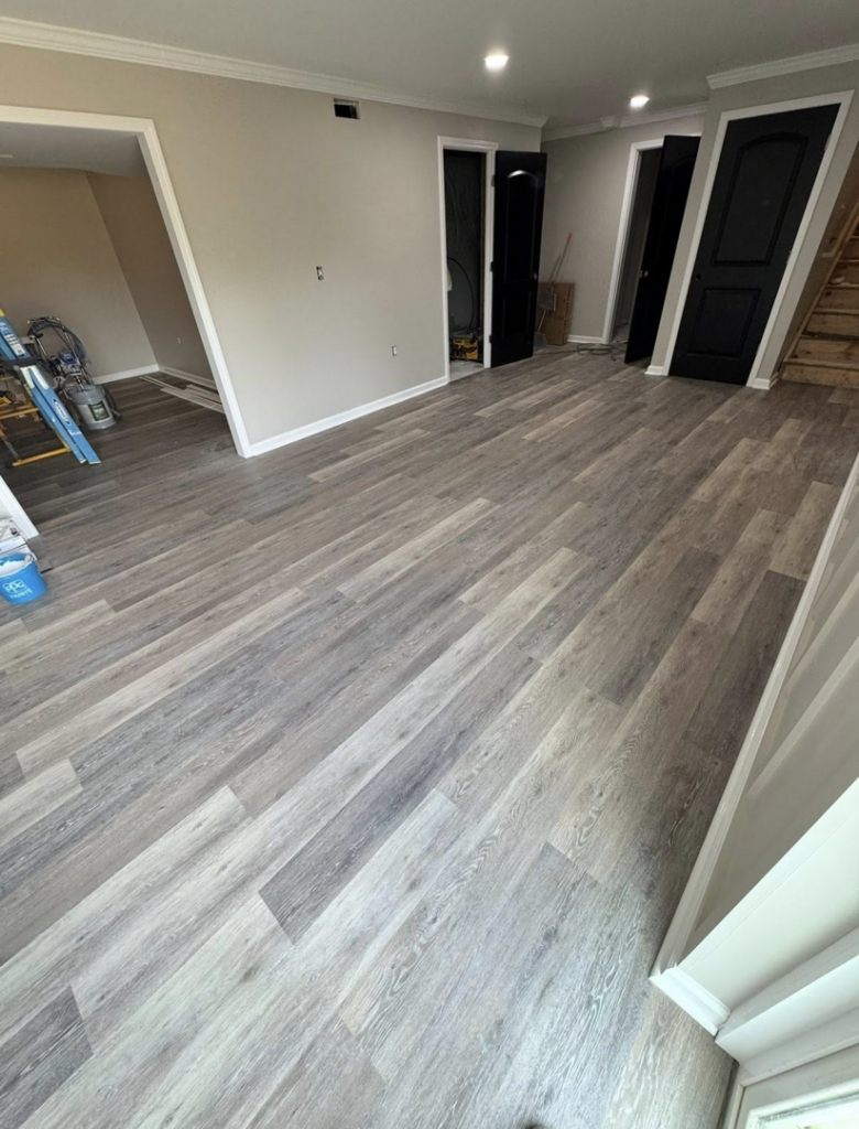 A newly finished basement area with new laminate flooring, painted walls, and trim by Jason Roberts Painting and Remodeling in Louisville, KY.