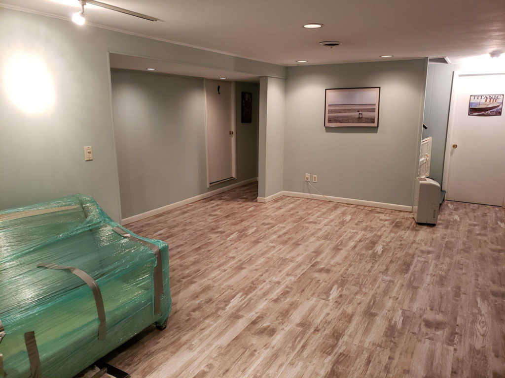 Finished basement with new flooring, paint, and trim by Excel Home Improvement And Services in Pawling, NY