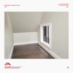 A neatly finished basement nook with dark wood flooring and a decorative vent, part of a remodeling project by Alba General in Madison, WI.