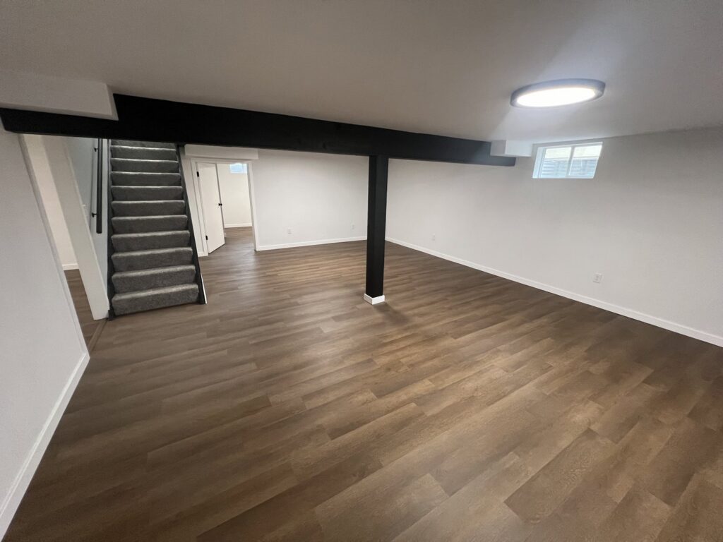 A newly finished basement remodel with new flooring and paint by Smitty's Handyman Service LLC in Mesquite, TX.