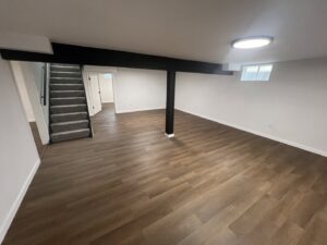 A newly finished basement remodel with new flooring and paint by Smitty's Handyman Service LLC in Mesquite, TX.