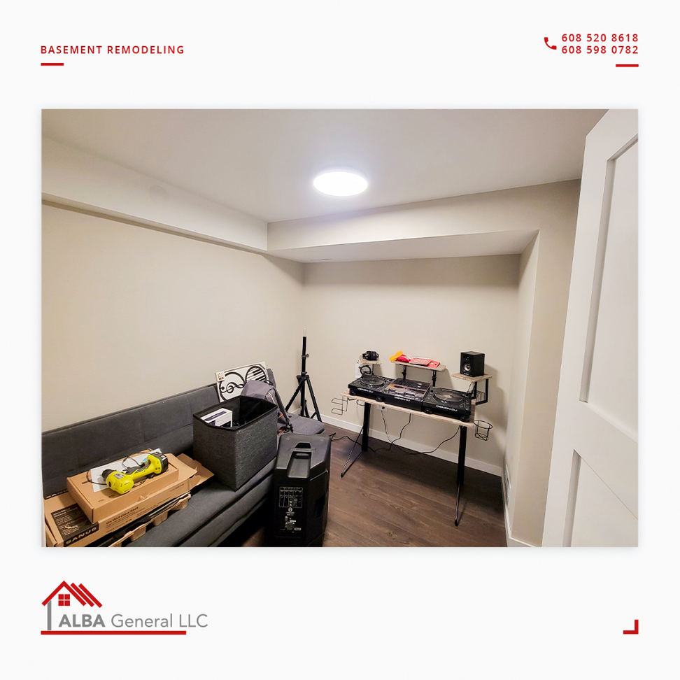 A newly finished basement room with modern lighting and flooring, completed by Alba General in Madison, WI.