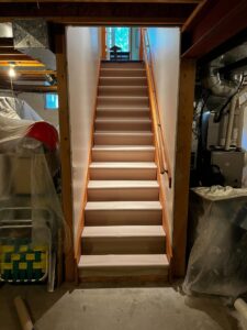 Newly finished basement stairs after renovation by ARK Basement Services - Erie, PA