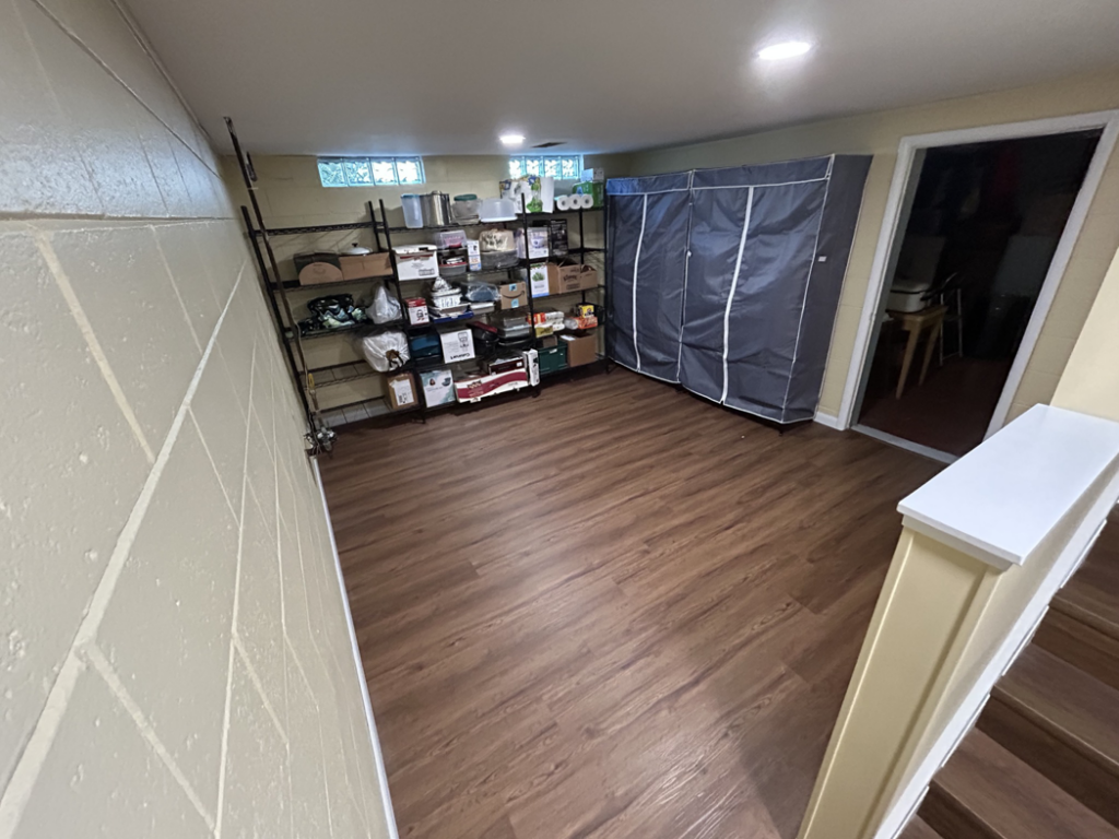 Finished basement with new flooring and storage solutions by Steve Way Builders, LLC in Lansing, MI
