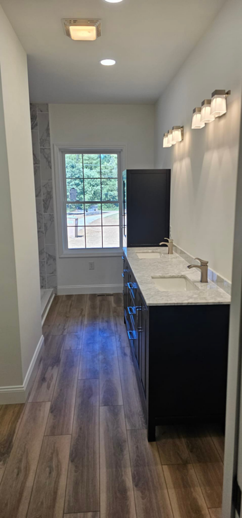 A spacious finished bathroom featuring a double vanity and modern fixtures by Susquehanna Valley Builders in Harrisburg, PA.