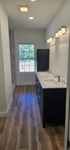 A spacious finished bathroom featuring a double vanity and modern fixtures by Susquehanna Valley Builders in Harrisburg, PA.