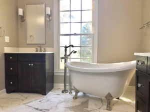 A beautifully finished bathroom featuring a freestanding tub and modern vanity by The Womack Group / Home Service Plus, LLC in Franklin, TN