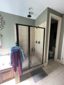 A finished bathroom shower installation with glass doors and tiled walls by RIBAM Residential contractor.llc in Auburn, AL.
