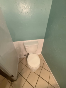 Completed bathroom toilet area with freshly painted walls and installed wainscoting by Duane Moss Painting in Oklahoma City, OK.