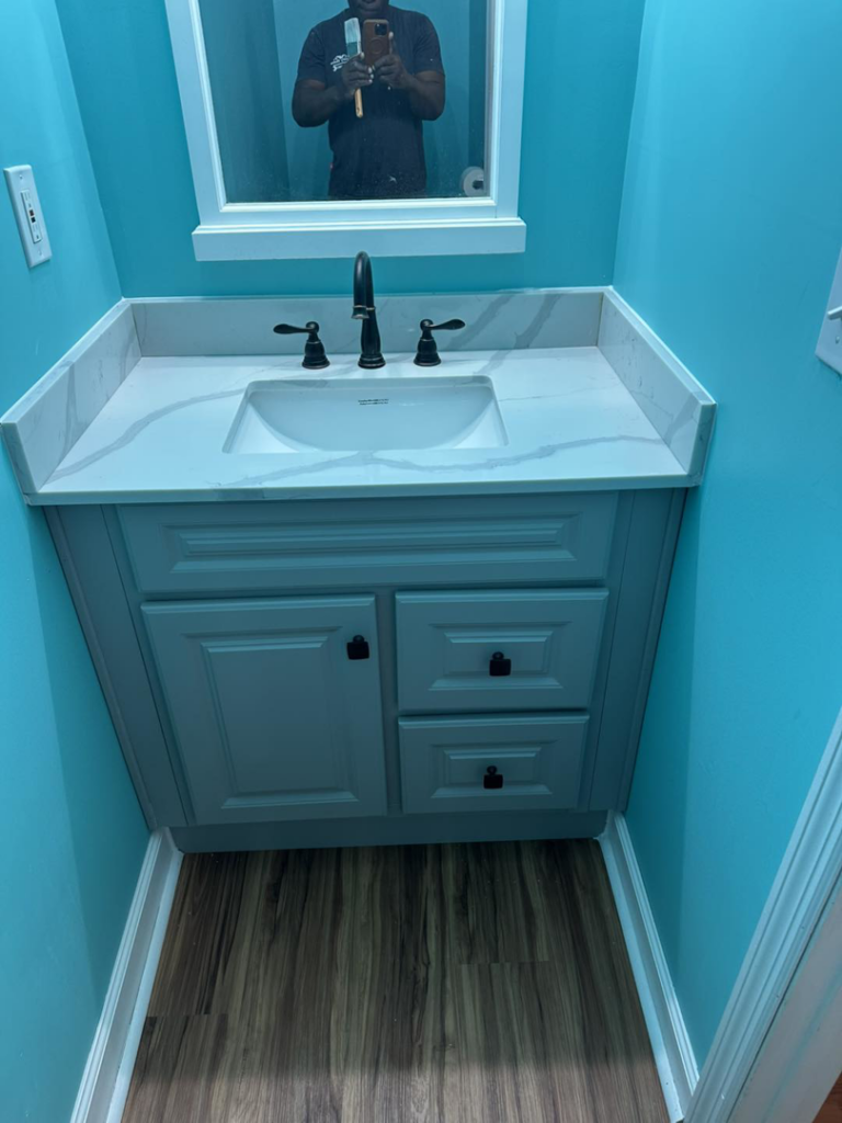 A finished bathroom vanity with a new sink and faucet installed by Quality Home Maintenance Services LLC in Raleigh, NC