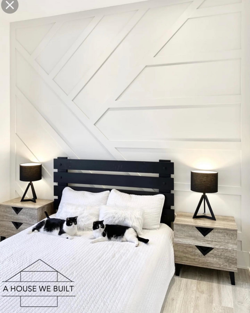 A beautifully finished bedroom featuring a modern geometric accent wall by UpGray'D Remodeling LLC in Chicago, IL