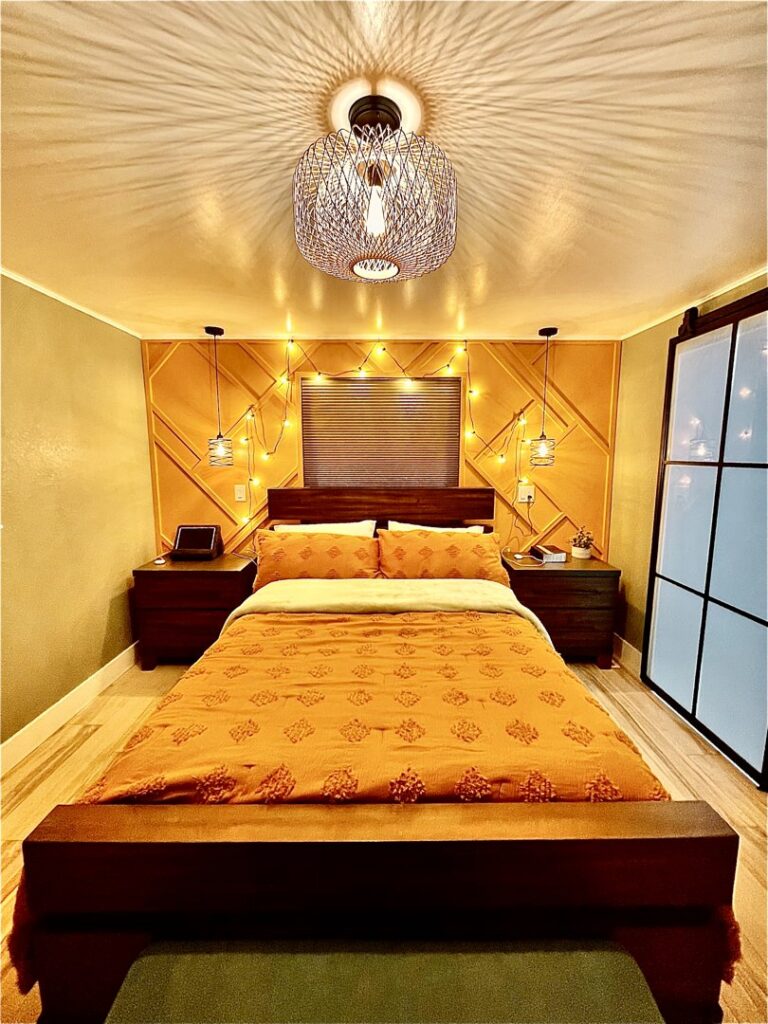 Finished bedroom design with custom lighting and wall decor by Denver House Repair in Lakewood, CO.