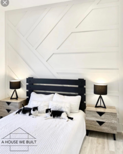 A beautifully finished bedroom with a modern geometric accent wall by UpGray'D Remodeling LLC in Chicago, IL.
