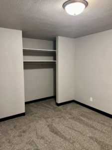 A completed bedroom renovation with new carpet and fresh paint by Get It Done in Sioux Falls, SD.