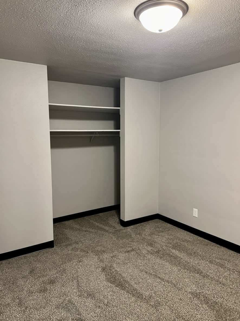 A completed bedroom renovation with new carpet and fresh paint by Get It Done in Sioux Falls, SD.