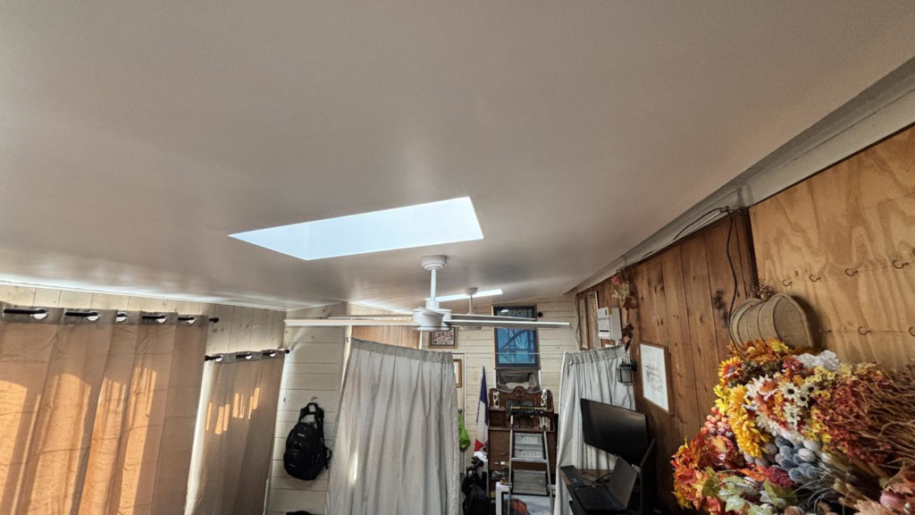 A newly finished ceiling with a skylight and ceiling fan installed by Build Brothers in Providence, RI