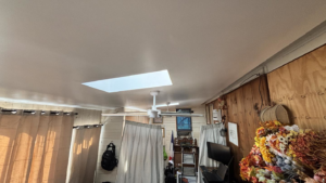 A newly finished ceiling with a skylight and ceiling fan installed by Build Brothers in Providence, RI