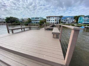 A finished composite deck with built-in benches overlooking a waterfront, a project by Bayside Concrete & Construction in Tampa, FL