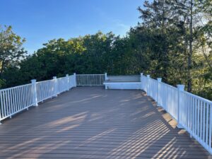 A newly finished composite deck with white railings by Wood Trades LLC in Westport, MA.