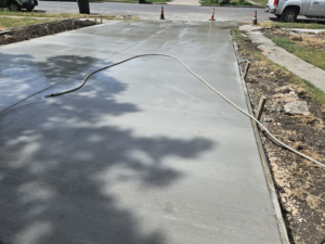 A freshly poured and finished concrete driveway for a residential property by Requena Concrete San Tex in San Antonio, TX