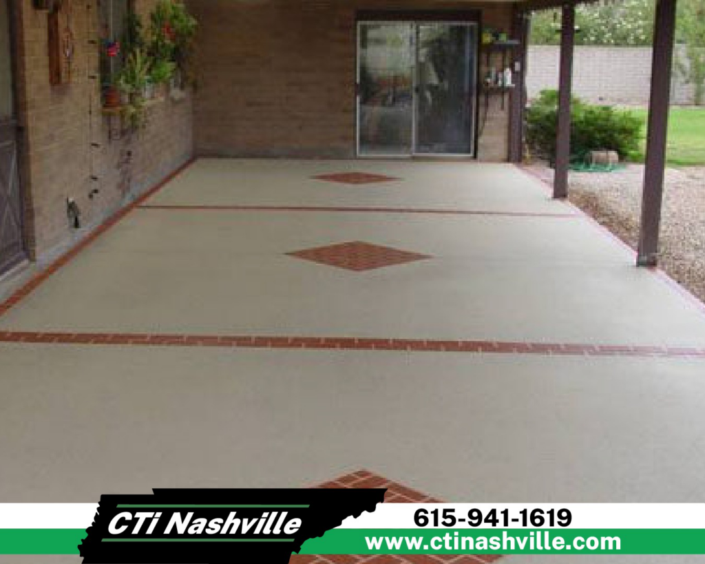 A finished concrete patio with decorative brick borders and inlays, expertly completed by CTi Nashville in Antioch, TN.