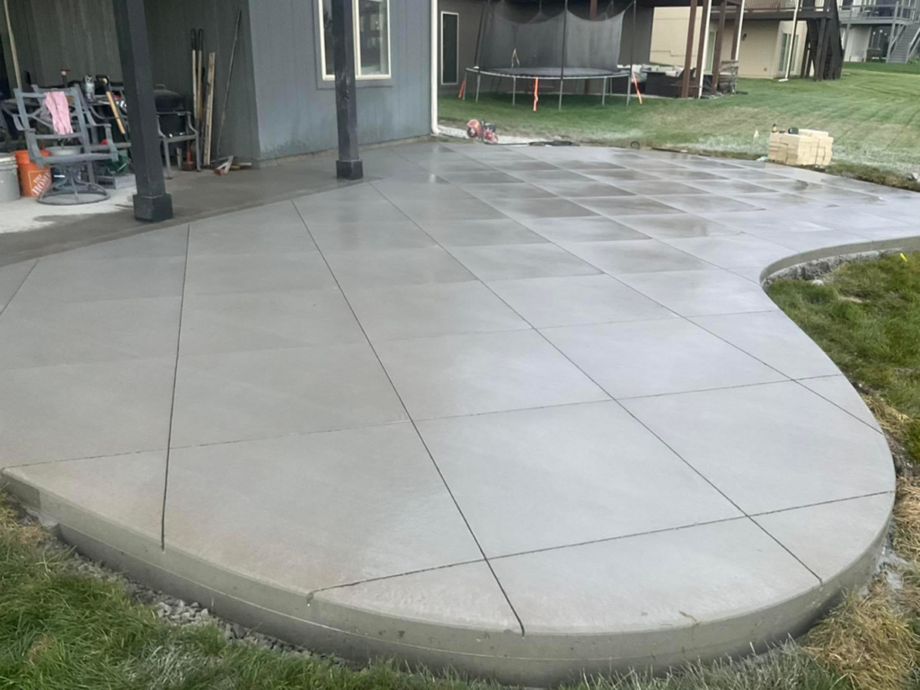 A newly poured and finished concrete patio with expansion joints by Cervantes Concrete Llc in Caledonia, WI.