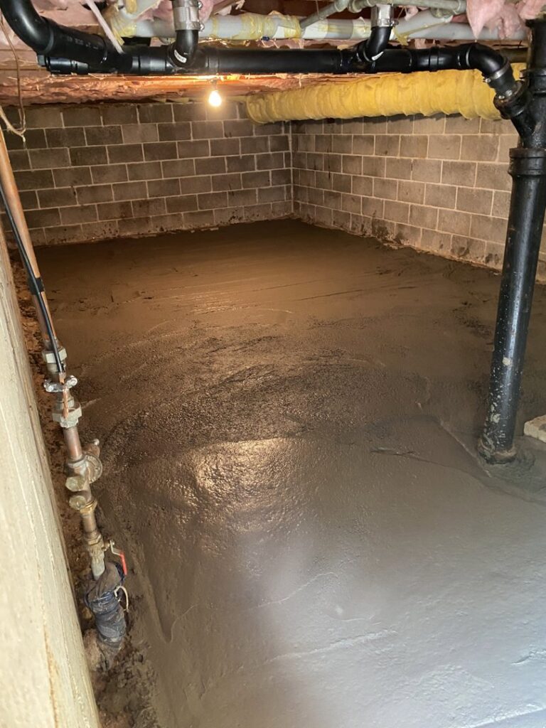 A clean and finished crawl space with a smooth concrete or sealed floor, indicating professional encapsulation work by Northwest Crawl Space Services in Kent, WA.