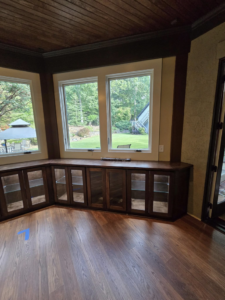 Completed custom dark wood cabinet installation with glass doors by Sanchez Construction Services in Laredo, TX.