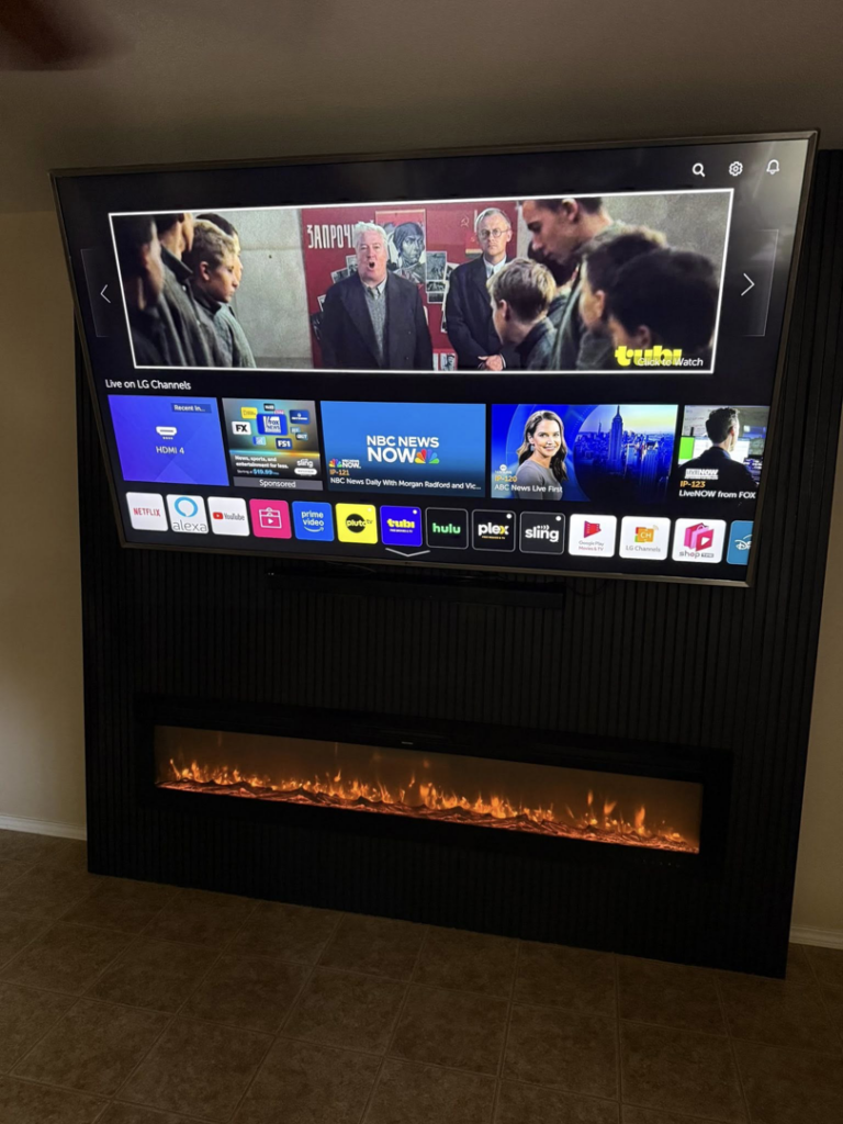 A finished custom TV and electric fireplace wall unit installed by Camacho's Construction LLC in Laredo, TX.