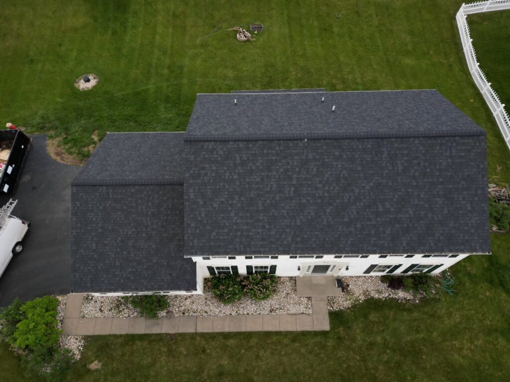 Aerial view of a house with a finished dark gray shingle roof installed by Moonshot Roofing in Columbia, PA.
