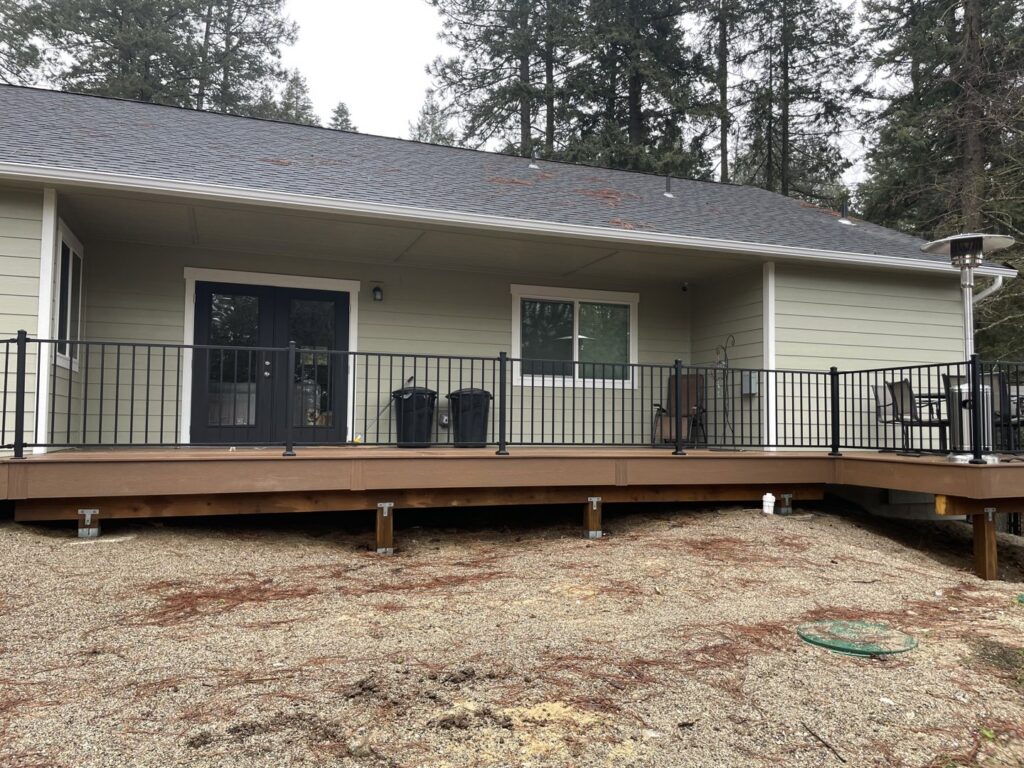 A newly finished deck featuring sleek black metal railing, expertly constructed by Ridgeline Decks in Spokane, WA.