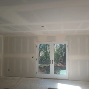 A room with newly finished drywall installation and French doors, completed by JLSL Drywall LLC in Salem, OR.