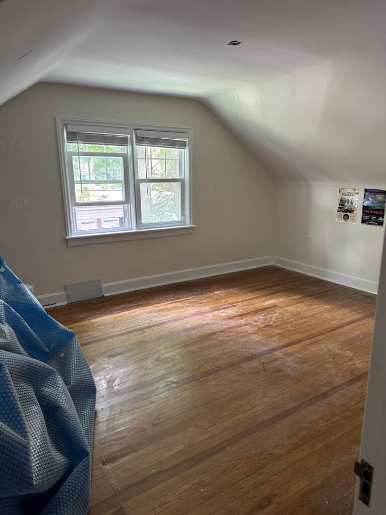 An empty room with smoothly finished drywall and plaster walls and ceiling, ready for painting by N. Bennecoff Drywall & Plaster in Lancaster, PA.