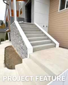 Newly finished exterior concrete stairs leading to a modern home, a project completed by Alpha Railing Company in Tacoma, WA.
