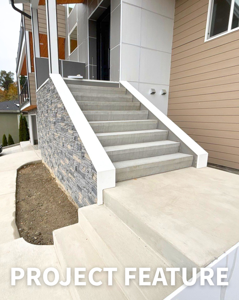 Newly finished exterior concrete stairs leading to a modern home, a project completed by Alpha Railing Company in Tacoma, WA.